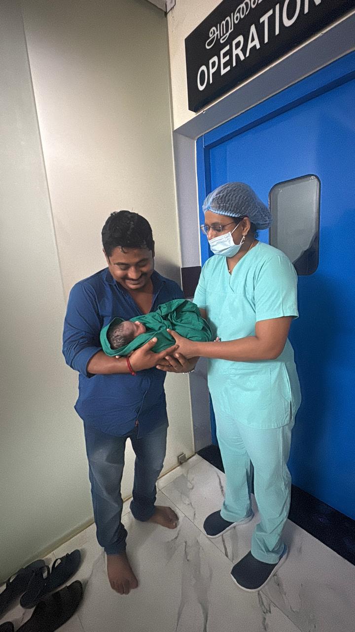 Newborn handed to father outside the operation theatre at Sri Sai Clinic & Scans
